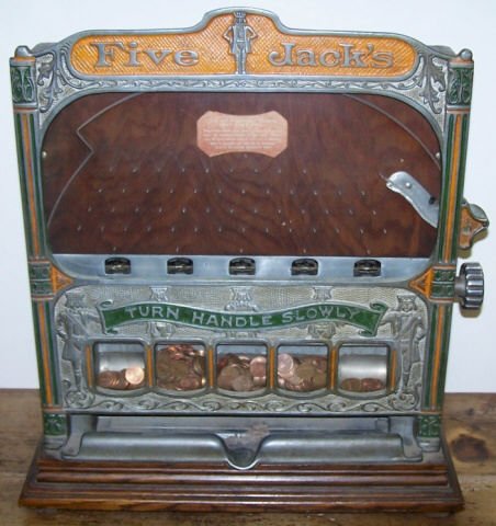 *COIN OPERATED FIVE JACKS SLOT MACHINE: In oak case, made by Rock-olla Company, circa 1930.