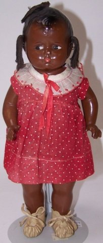 *EFFANBEE BLACK GRUMPY DOLL: Composition and cloth with molded hair and 3 yarn braids, having painted eyes and lips, marked on back "Effanbee Dolls, Walk-Talk-Sleep," approximate height 12".