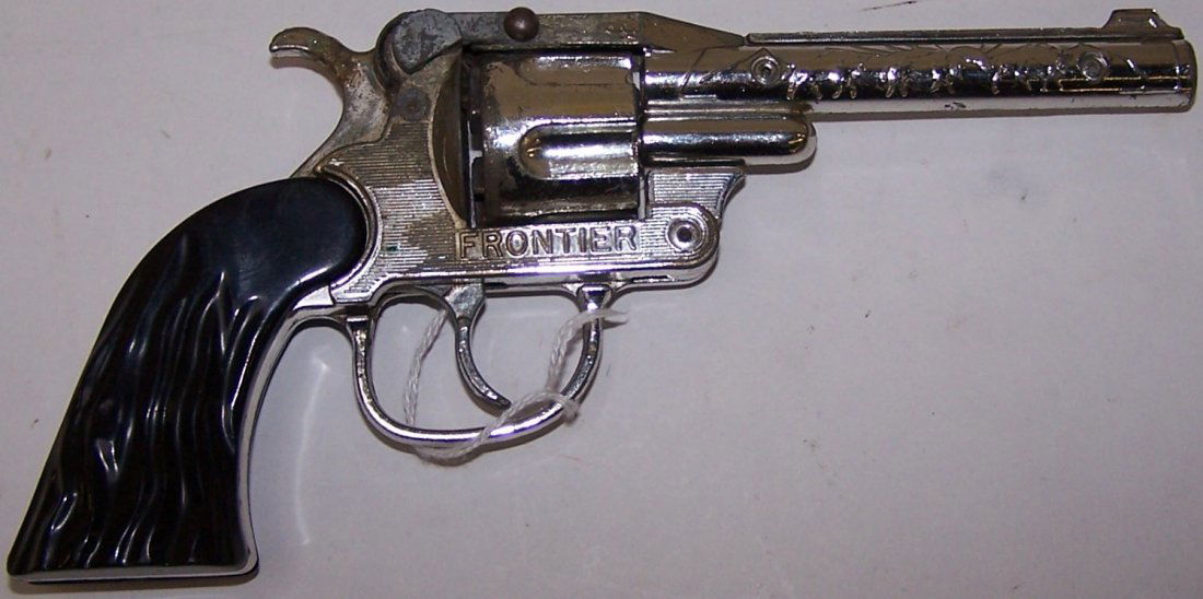 *HUBLEY FRONTIER REVOLVER CAP GUN: Approximately 9" long, having steers embossed on barrel, "Frontier" embossed on body under cylinder, black plastic grips with tip up configuration.