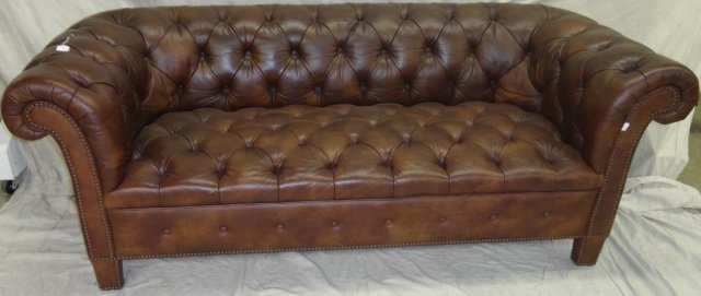 *CHESTERFIELD SETTEE: Having brown tufted leather upholstery, approximate height 28", width 72".