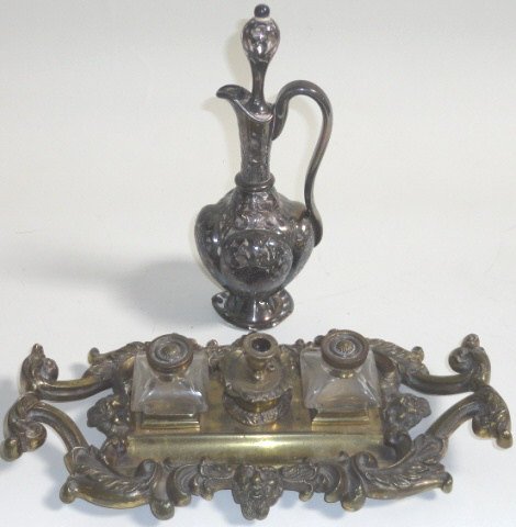 *2 PIECES: Brass ink well having 2 bottles centered by candleholder and leafy scroll frame, together with silver overlay cruet.