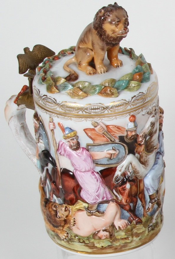 *CAPODIMONTE POTTERY STEIN: Surmounted with fully moddled lions surrounded by leaves, the body surrounded by lions attacking warriors and having figural thumb lift depicting eagle and approximate height 10 1/2".