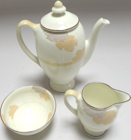 GROUP: 3 Piece Royal Doulton Art Deco coffee service, coffee server, approximate height 8", creamer, sugar and an early 19th C. Spode porcelain drainer having floral decoration, approximate diameter 14 1/2".