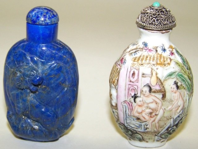 *2 ORIENTAL SNUFF BOTTLES: Carved lapis decorated with lion, approximate height 2 1/4" and porcelain with relief decoration depicting erotic scene, signed on underside, height 2 1/4".