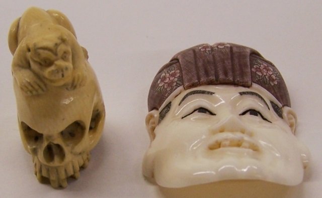 *2 PIECES OF CARVED IVORY: Netsuke depicting foo dog atop skull and a mask of Asian gentleman, skull signed on back, mask signed on underside. Note: Items containing ivory will only be shipped domestically and cannot be shipped