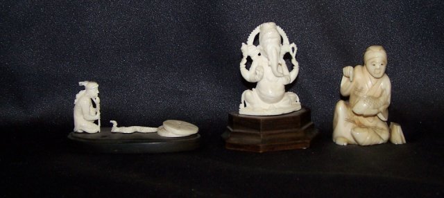 3 CARVED IVORY FIGURES: Snake charmer, approximate height 1" without stand, gentleman holding fish, height 2" and a deity, height 2" without stand. Note: Items containing ivory will only be shipped domestically and cannot be