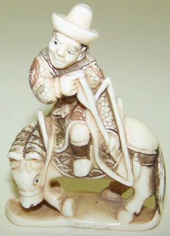 *CARVED IVORY NETSUKE: Horse and rider, signed on underside "Gyokusen". Note: Items containing ivory will only be shipped domestically and cannot be shipped to California.