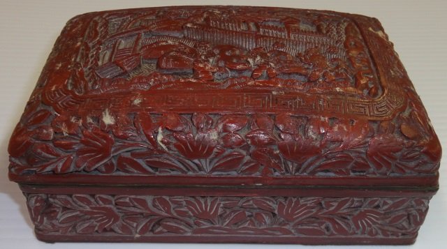 *CINNABAR DRESSER BOX: With carved decoration depicting figures and landscape, approximate height 2", width 5 3/4", depth 3 3/4".