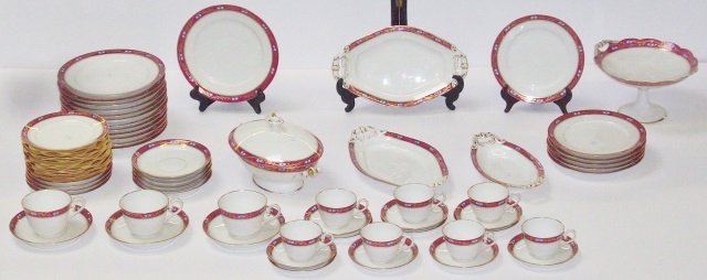 SET OF BAWO & DOTTER PORCELAIN DINNERWARE: Burgundy rims with floral and gilt decoration, 13 dinner plates, 6 salad plates, 12 bread plates, 2 two-handled serving platters, vegetable bowl, covered casserole, compote, 3 coffee cups, 8 saucers, 