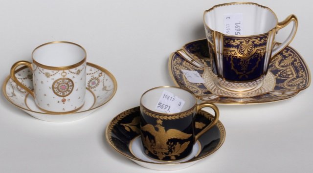*3 DEMITASSE CUPS & SAUCERS: Spode 1890-1903 with cobalt and gilt decoration, Sevres circa 1890 decorated with cobalt ground and gilt eagle and Sevres 1845 having white ground decorated with gilt bee, all marked on underside.