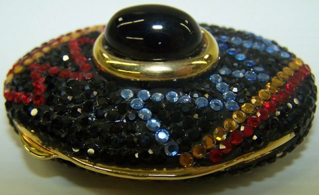 *JUDITH LEIBER STYLE TRINKET BOX: Having blue, red, yellow rhinestones with black ground, approximate diameter 1 1/4".