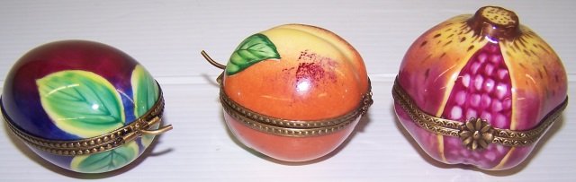 *3 LIMOGES PORCELAIN TRINKET BOXES: pomegranate, approximate height 2", peach, height 2 1/4" and plum, height 2 3/4".