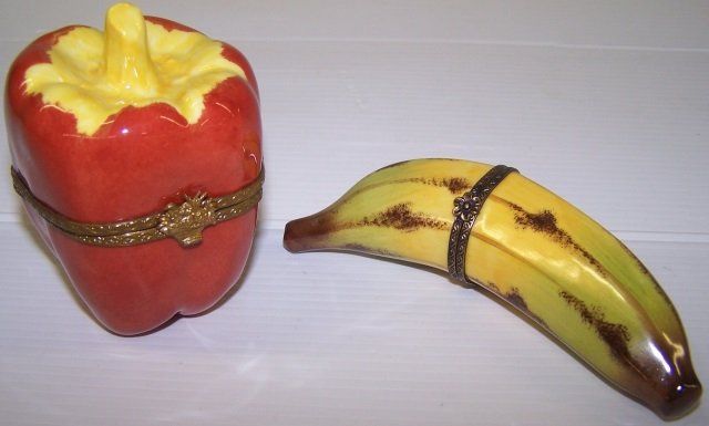 *2 LIMOGES PORCELAIN TRINKET BOXES: Red pepper, approximate height 3 1/4" and banana, height 4 3/4".