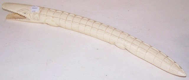 CARVED IVORY SCULPTURE: Alligator. Note: Items containing ivory will only be shipped domestically and cannot be shipped to California.