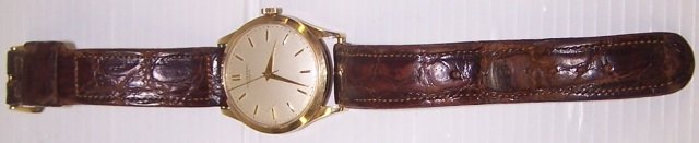 *MAN'S UNIVERSAL GENEVE 14K YELLOW GOLD WRISTWATCH: Having jeweled movement, stem wound and set with bar markers on a white finish dial, contained in a circular 14k yellow gold case, fitted with brown leather straps.