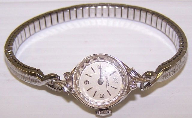*LADY'S GERARD PERREGAUX WRISTWATCH: Having 17 jeweled movement with Arabic and bar markers on a white finish dial, contained in a gold filled and diamond case with a Speidel band.