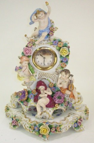 *DRESDEN PORCELAIN MANTEL CLOCK: Having applied floral and cherub decoration, with Kaiser German movement )clock resting on separate base), approximate overall height 13".