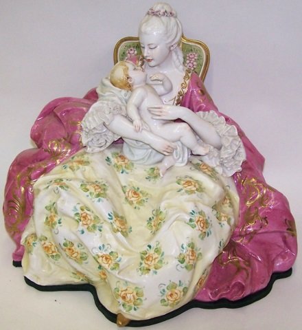 *PORCELAIN FIGURAL GROUPING: Capodimonte, seated 18th C. woman holding baby, approximate height 17 1/2".