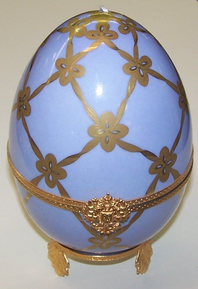 *FABERGE EGG: Having musical movement, light blue ground and gilt decoration, opening to figure of swan and numbered 365, approximate height 7".