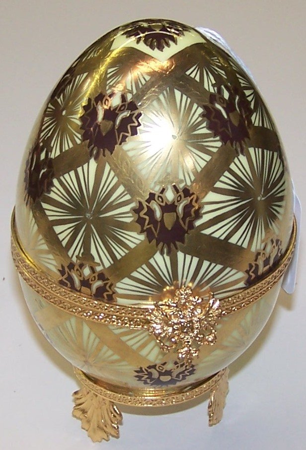 *FABERGE CORONATION EGG: Having gilt decoration and opening to carriage, numbered 126, approximate height 6".