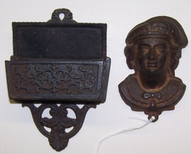 *2 CAST IRON MATCH POCKETS: Christopher Columbus, and 1 with hinged top and scroll decoration, approximate height 4" and 5 1/2".