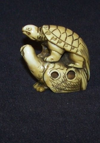*IVORY NETSUKE: Turtle standing on pelican, approximate height 1 1/2". Note: Items containing ivory will only be shipped domestically and cannot be shipped to California.