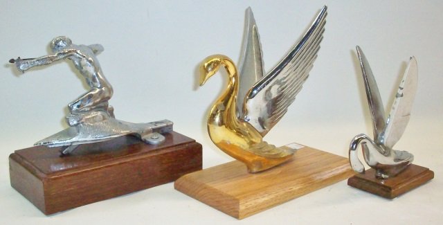 *3 AUTOMOBILE HOOD ORNAMENT MASCOTS: 1948 Packard swan, Pierce arrow bareheaded archer, and Packard style swan, all mounted to or resting on custom wood bases.