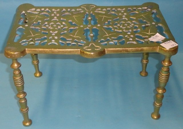 *BRASS FIREPLACE TRIVET: With leaf decoration, approximate height 6", width 9 3/4", depth 6 1/4".