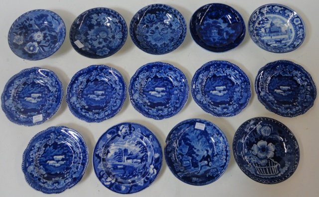 *14 19TH C. FLOW BLUE SAUCERS: Marked on underside "Staffordshire Clews", decorated with flora, urns, sheep, etc., approximate diameter 5 3/4".