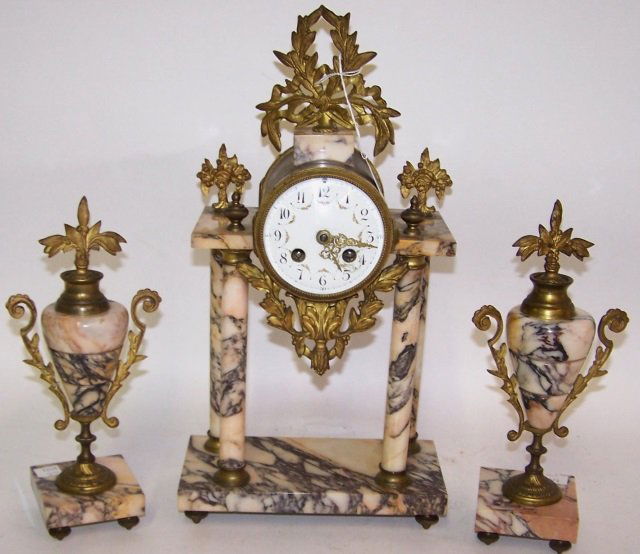 *3 PIECE CLOCK GARNITURE SET: Mantle clock fitted with time and strike movement, the enamel dial having Arabic numeral markers enclosed in marble and brass architectural style case, approximate height 16 3/4" and pair of matching