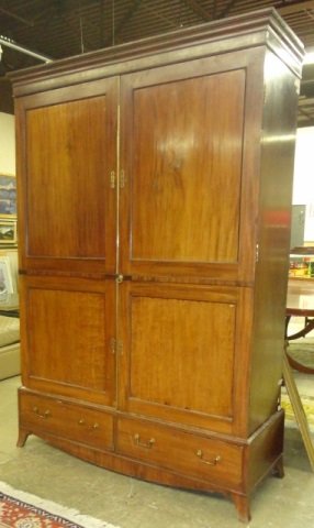 19TH C. MAHOGANY WARDROBE: By W. Williamson & Sons, ca.1820, having flat molded cornice over 2 paneled doors, raised on base fitted with 2 drawers below, approximate height 88 3/4", width 60", depth 23".