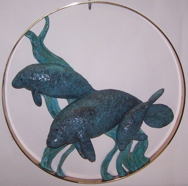 *WYLAND, ROBERT: "Manatee Family", bronze sculpture, signed and numbered 116/300, approximate diameter 22 7/8", depth 4 3/4".