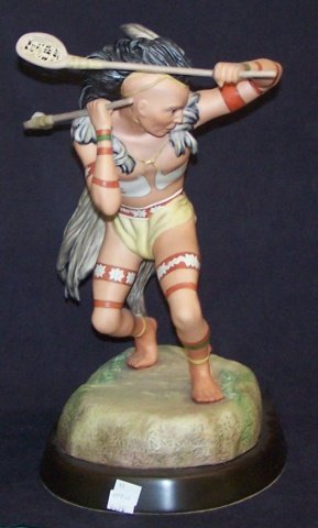 *CYBIS PORCELAIN FIGURE: Indian warrior playing game, signed "Cybis USA #70", raised on hardwood base, approximate figure height 14 1/2", with base 16". D3