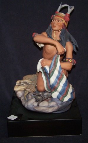 *CYBIS PORCELAIN FIGURE: Kneeling Indian with blanket and fire, signed "Cybis USA #296", raised on hardwood base, approximate figure height 10 1/2", with base 12 1/2". D3