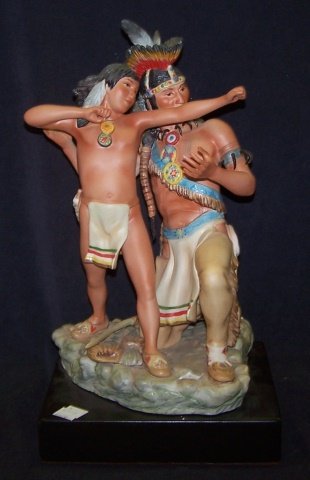 *CYBIS PORCELAIN FIGURAL GROUP: Cree Indians "Magic Boy", raised on wood base, approximate figure height 13", with base 15". D3