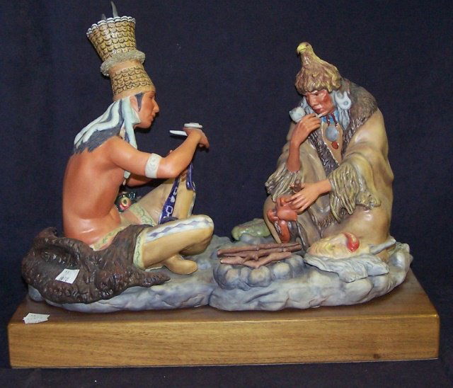 *CYBIS PORCELAIN FIGURAL GROUP: 2 seated Indians smoking pipes, signed "Cybis USA #63", raised on hardwood base, approximate figure height 12", with base 14". D3