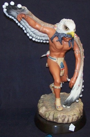 *CYBIS PORCELAIN FIGURE: Indian medicine man with eagle headdress, signed "Cybis USA #91", raised on hardwood base, approximate figure height 18 1/2", with base 20". D3