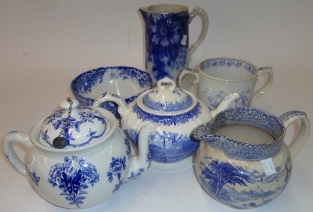 *7 PIECES OF FLOW BLUE AND BLUE & WHITE PORCELAIN: Footed bowl marked "Bonn", approximate height 3 1/2", pitcher with relief decoration depicting hunters, height 5 3/4", 2-handled marriage cup decorated with fowl, height 5", pitcher with gilt highligh