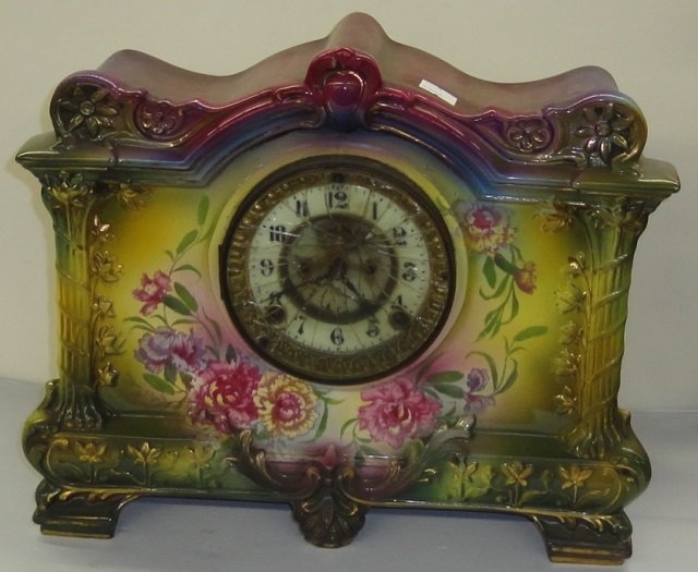 *ANSONIA MANTEL CLOCK: Fitted with time and strike movement, the enamel dial having Arabic numeral markers enclosed in Royal Bonn porcelain case with floral decoration, approximate height 11 3/4", width 14", depth 4 1/2".