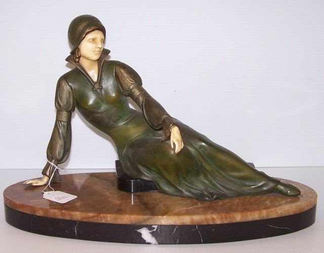 *CIPRIANI SCULPTURE: Seated young lady, having spelter body with faux ivory face and hands, raised on oval marble base, approximate height 12", length 17 1/2".