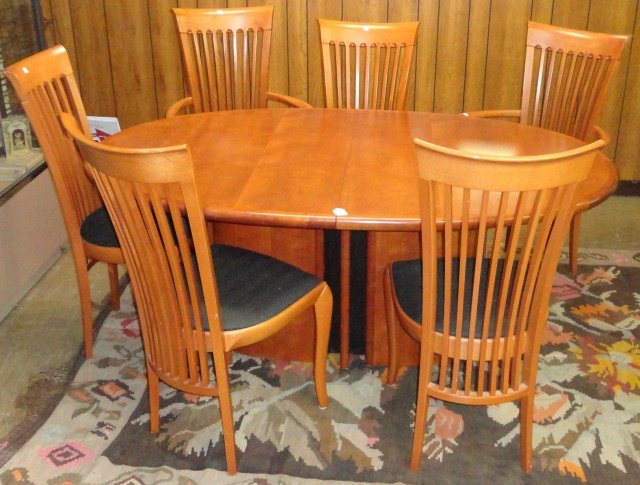 *7 PIECE SKOVBY DINING SET: The oval top raised on pedestal base, converting to larger table, approximate height 28 3/4", width 68", depth 42 1/2", complete with 2 armchairs and 4 side chairs with slat backs, height 40".