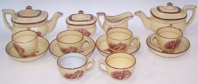 *CHILD'S ENGLISH CREAMWARE PORCELAIN TEA SET: Decorated with mother and child, 2 teapots, approximate height 3 1/4", creamer, sugar, 4 saucers and 6 cups.