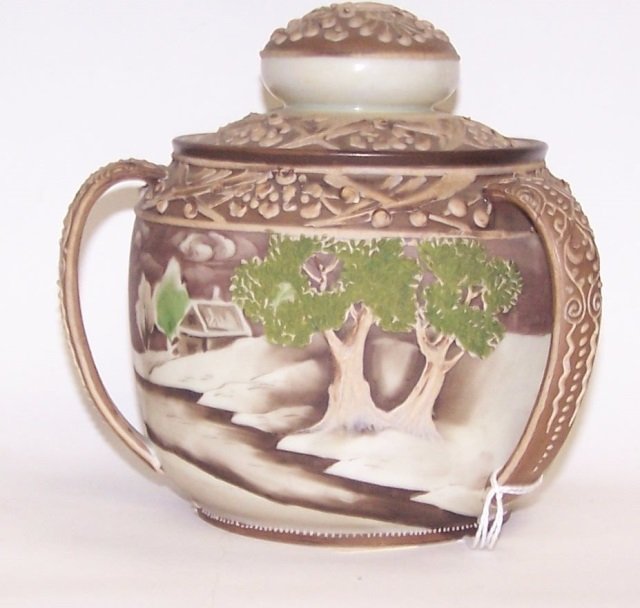 *NIPPON HANDPAINTED PORCELAIN HUMIDOR: Having relief decoration of house in landscape, approximate height 5 1/2".