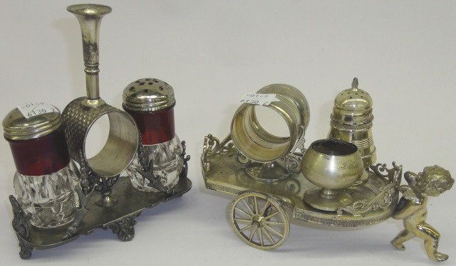 *2 VICTORIAN NAPKIN RING HOLDERS: 1 fitted with pair of shakers centered with bud vase, 1 on cart form stand being pulled by putti, fitted with shaker and salt.