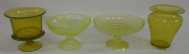 *4 PIECES OF VASELINE GLASS: Footed vase, approximate height 7", and 2 footed bowls,1 decorated with grape clusters, height 5 1/2", and vase raised on 3 feet, height 7 1/2".