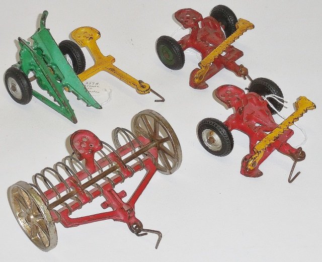*4 ARCADE CAST IRON FARM IMPLEMENTS: 2- side bar mowers, corn harvester and hay rake.