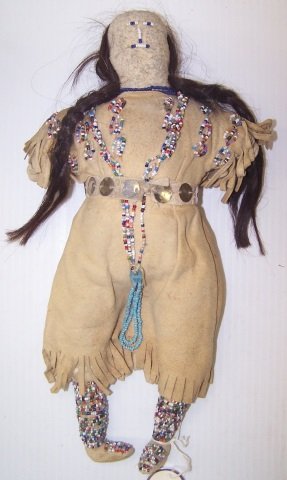 *NATIVE AMERICAN HIDE ,CLOTH AND BEADED DOLL: Decorated with multicolored beads, approximate height 12 1/2".
