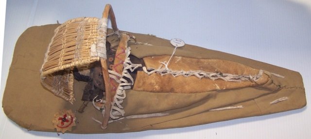 * NATIVE AMERCAN CRADLE BOARD: Made with hide, cloth ,beads and wood approximate length 23 1/2".