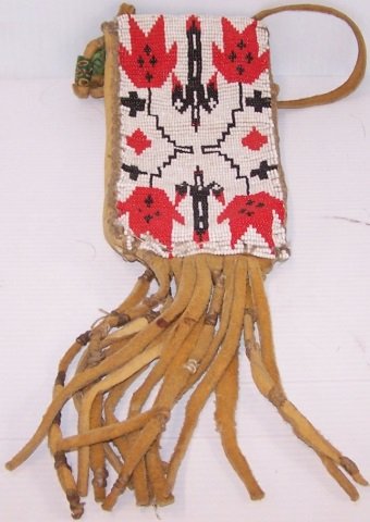 *NATIVE AMERICAN LEATHER AND BEADED BAG: "Storm" pattern, approximate height with handle and fringe 20 1/2", beaded bag alone 7 1/4".