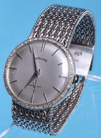*HAMILTON 14K WHITE GOLD AND DIAMOND WRISTWATCH: Having jeweled movement, stem wound and set, with bar markers on a silver finish dial, contained in a 14K white gold and diamond bezel set case and fitted with 14K white gold mesh design straps, appro